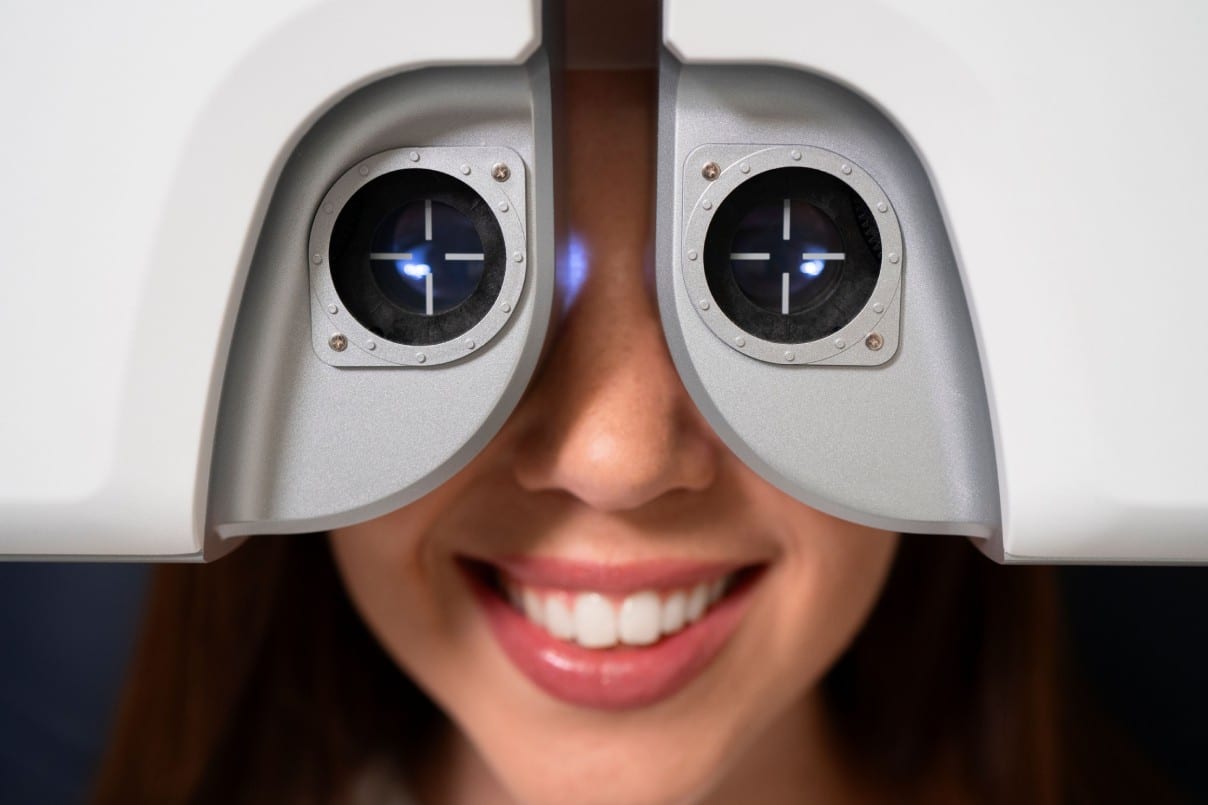 Woman undergoing precise eye test using advanced equipment.