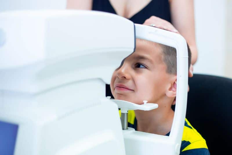 little boy at optometrists for eye test