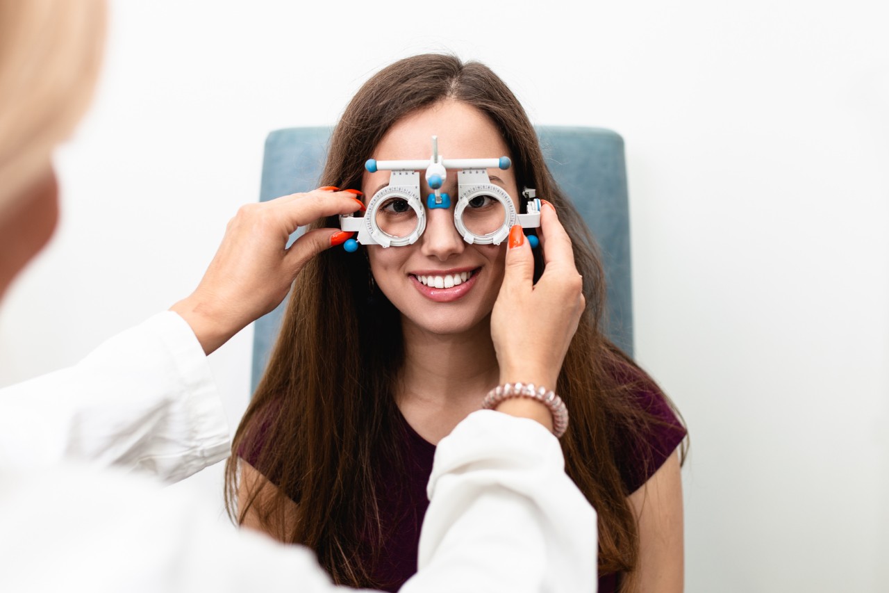 Young patient receiving eye test by an optometrist. 